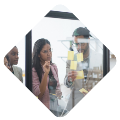 Group of Professionals looking at a Glass Screen With Notes